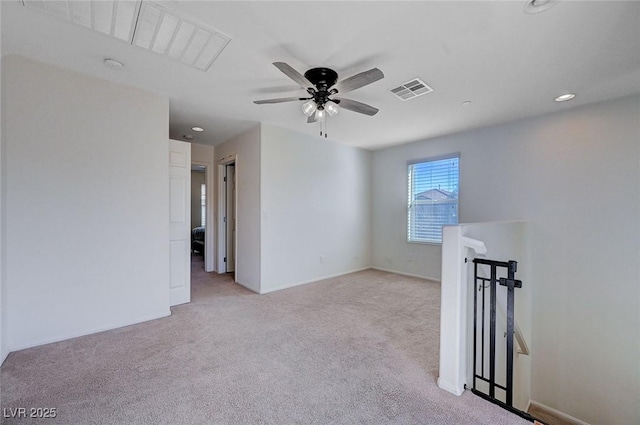 carpeted empty room featuring ceiling fan