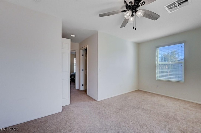 carpeted empty room featuring ceiling fan