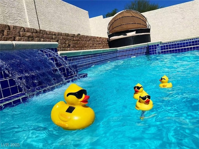 view of pool with pool water feature