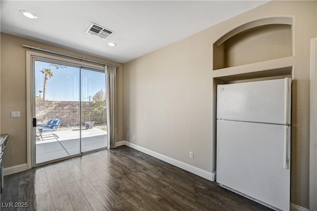 empty room featuring dark hardwood / wood-style flooring