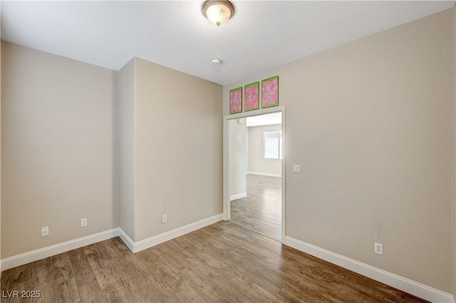 empty room with hardwood / wood-style flooring