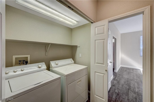 washroom with dark wood-type flooring and washer and dryer