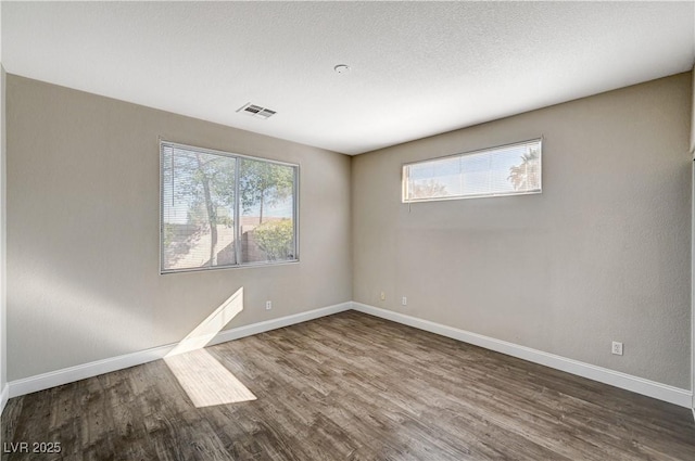 spare room with dark hardwood / wood-style floors