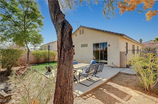 rear view of property featuring a patio area