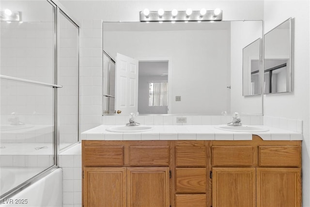 bathroom featuring vanity and combined bath / shower with glass door