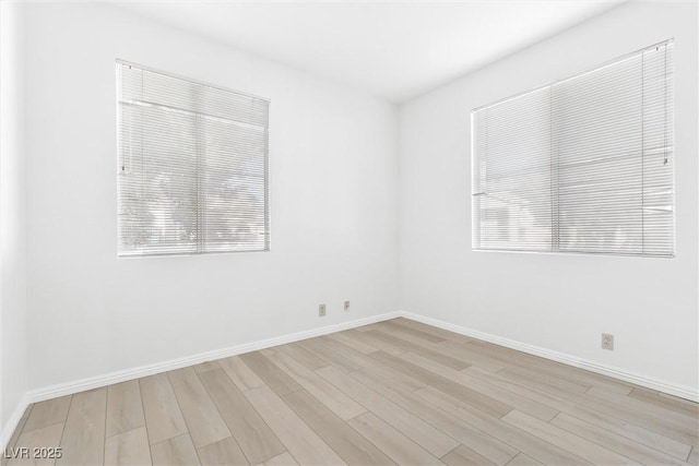 unfurnished room with light wood-type flooring