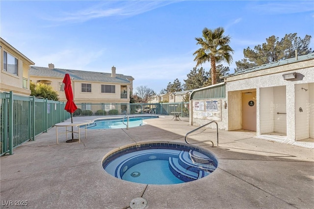 view of pool with a community hot tub and a patio area