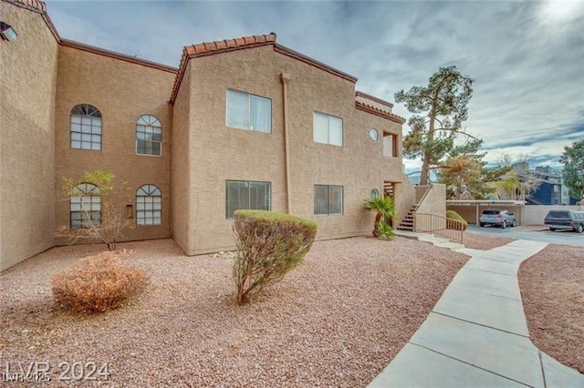 2983 Juniper Hills Blvd Unit 102, Las Vegas, NV 89142 - view of side of home featuring stucco siding and stairs