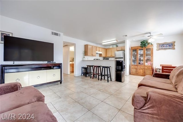 living room with light tile patterned floors and ceiling fan