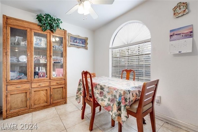 dining space featuring light tile patterned floors and ceiling fan