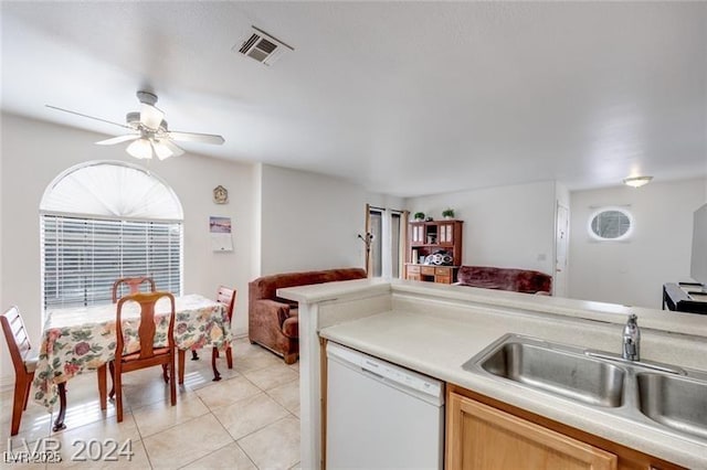 kitchen featuring light brown cabinetry, sink, light tile patterned floors, ceiling fan, and white dishwasher