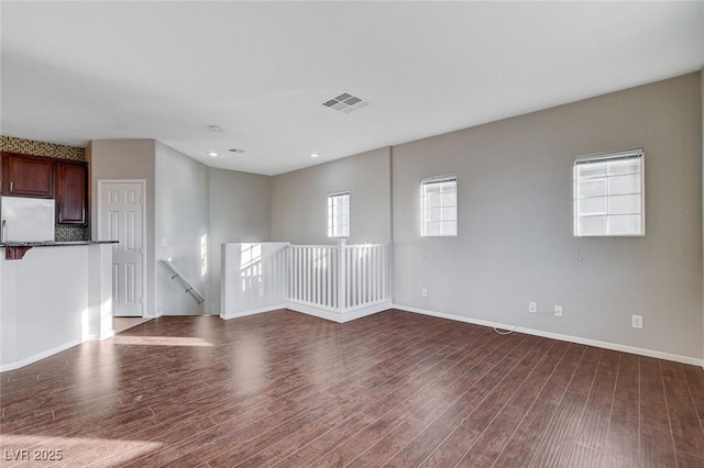 spare room featuring dark wood-type flooring