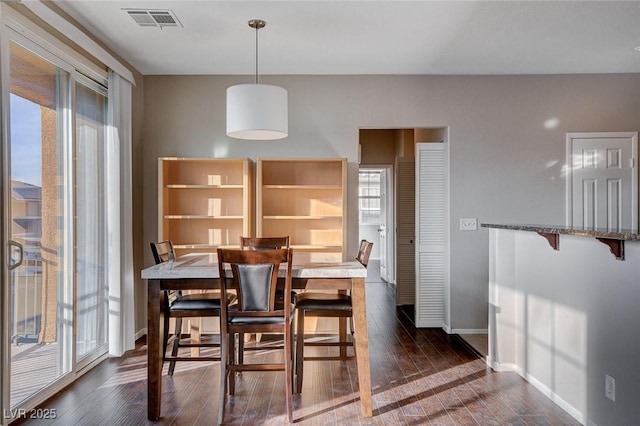 dining space with dark hardwood / wood-style flooring