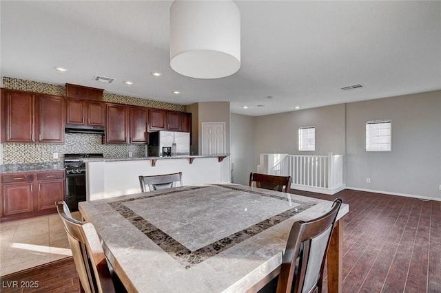 dining area featuring dark hardwood / wood-style flooring