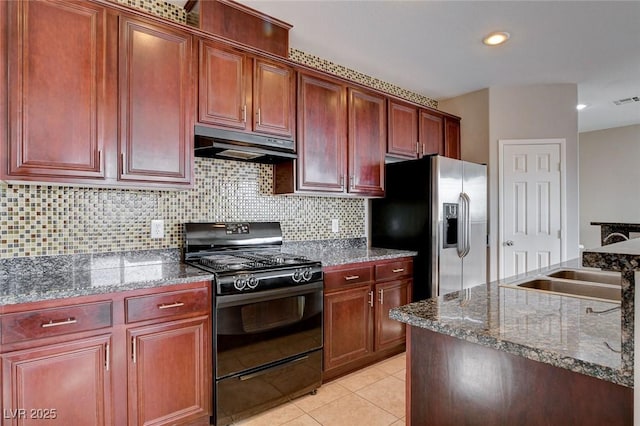 kitchen featuring sink, stainless steel fridge, black range with gas cooktop, light tile patterned flooring, and decorative backsplash