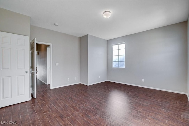 unfurnished room featuring dark hardwood / wood-style flooring