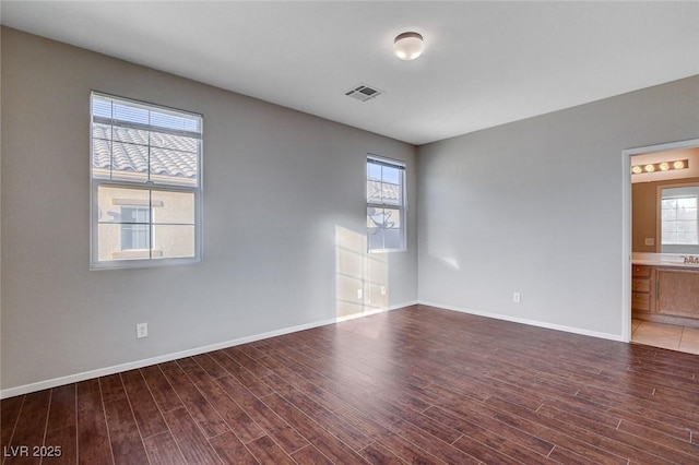 spare room featuring dark wood-type flooring