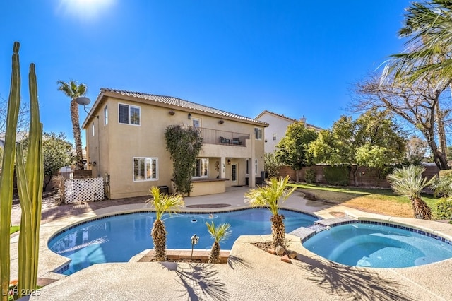 view of pool with an in ground hot tub