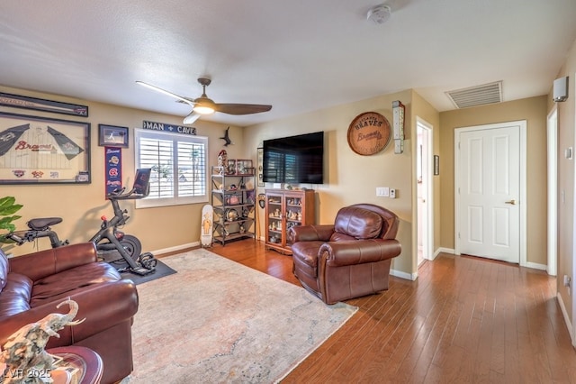 living room with hardwood / wood-style floors and ceiling fan