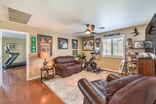 living room featuring ceiling fan and hardwood / wood-style floors