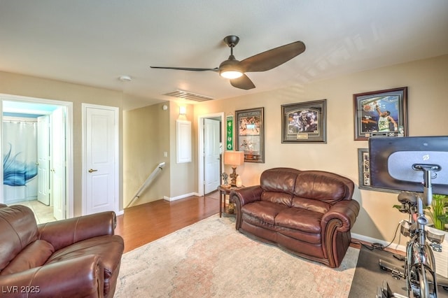 living room featuring hardwood / wood-style floors and ceiling fan