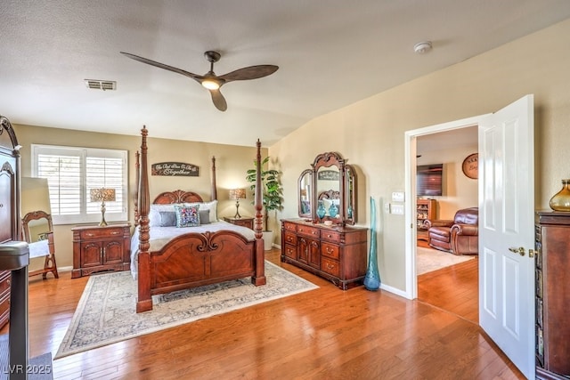 bedroom featuring lofted ceiling, light hardwood / wood-style floors, and ceiling fan