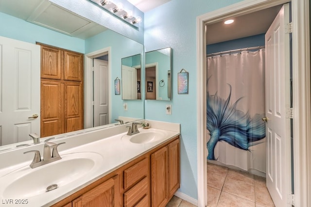 bathroom featuring tile patterned flooring and vanity