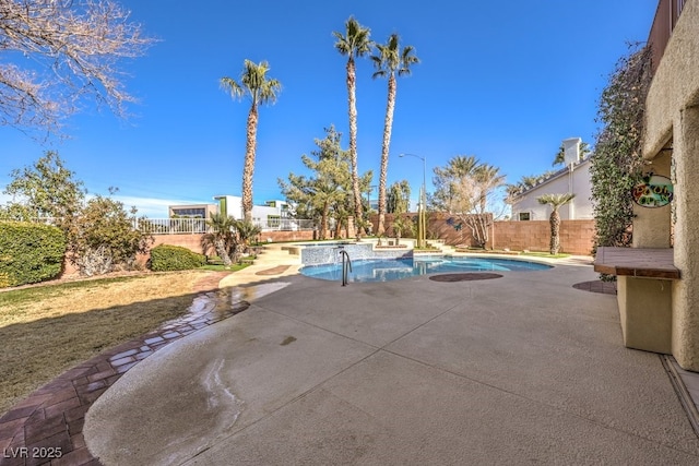 view of swimming pool featuring a patio and an in ground hot tub