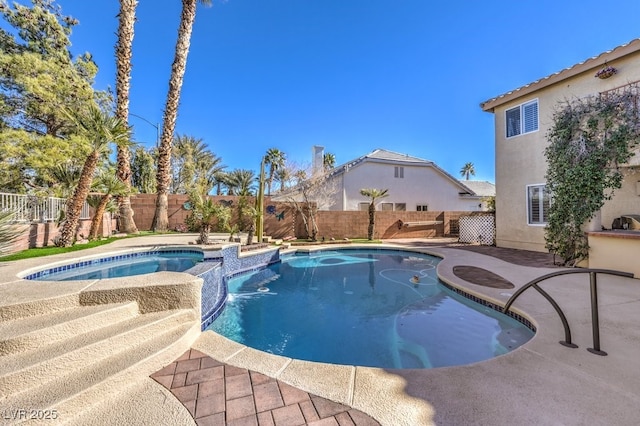 view of swimming pool with a patio and an in ground hot tub