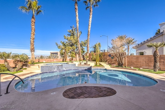 view of swimming pool with an in ground hot tub