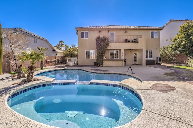 view of swimming pool featuring an in ground hot tub and a patio