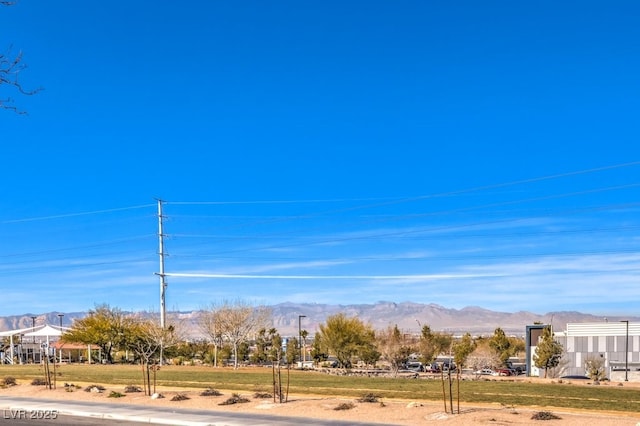 exterior space with a mountain view and a yard