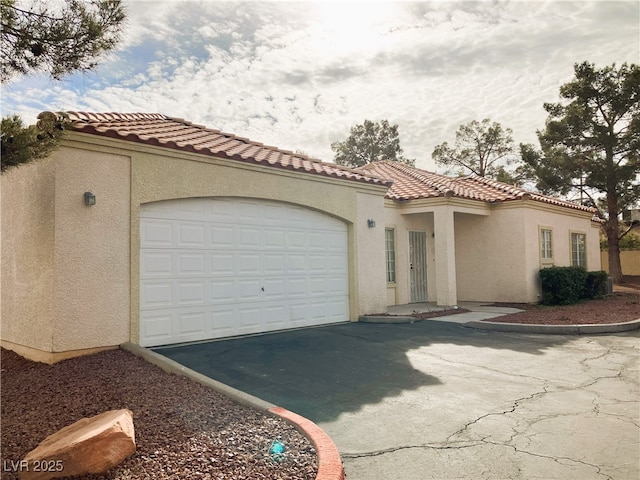 mediterranean / spanish-style home with a garage