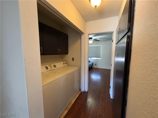 hallway featuring independent washer and dryer, a textured ceiling, a textured wall, and dark wood-style flooring