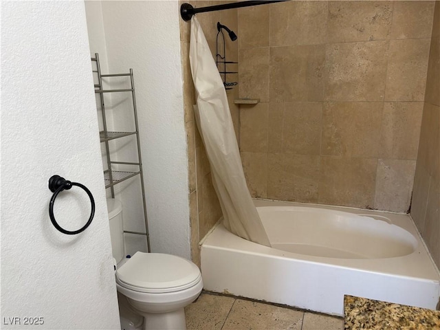 full bath with toilet, shower / bath combo with shower curtain, and a textured wall