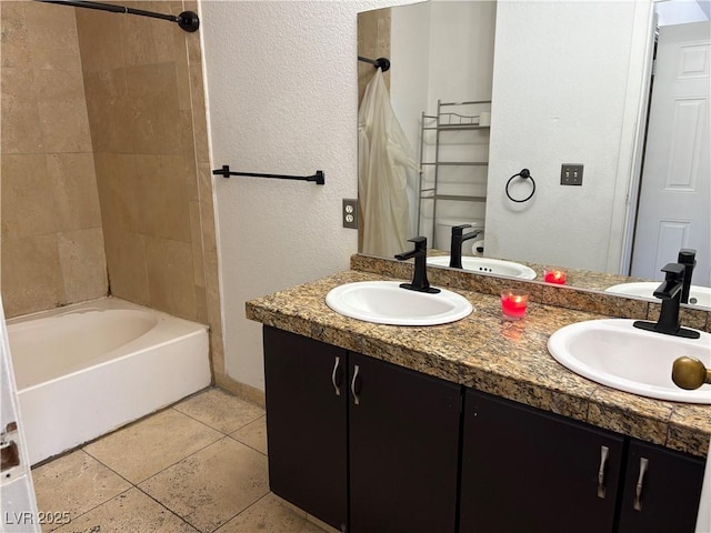 bathroom featuring a sink, shower / tub combo with curtain, and double vanity