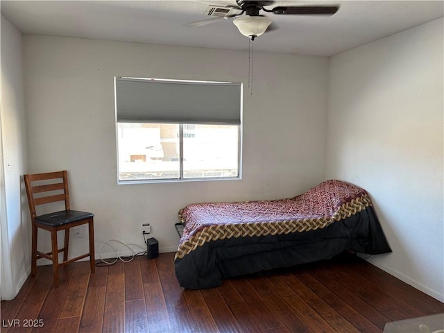 bedroom featuring a ceiling fan, visible vents, baseboards, and wood-type flooring