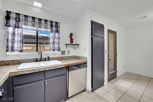 3891 Terrazzo Ave, Las Vegas, NV 89115 - kitchen featuring light countertops, a sink, dishwasher, light tile patterned floors, and visible vents