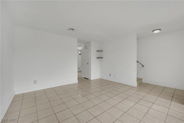 3891 Terrazzo Ave, Las Vegas, NV 89115 - spare room with light tile patterned floors, stairs, and visible vents