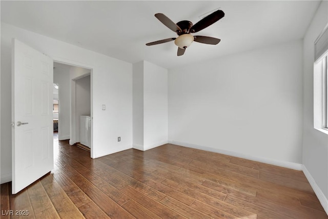 3891 Terrazzo Ave, Las Vegas, NV 89115 - spare room with plenty of natural light, dark wood-type flooring, baseboards, and ceiling fan