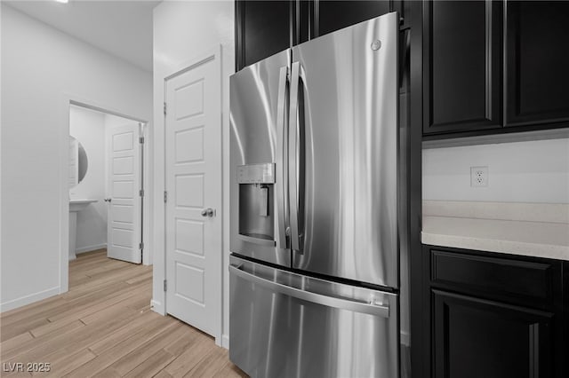 kitchen featuring stainless steel fridge and light hardwood / wood-style floors