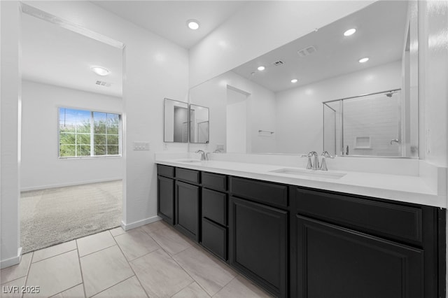 bathroom with vanity, tile patterned floors, and a shower