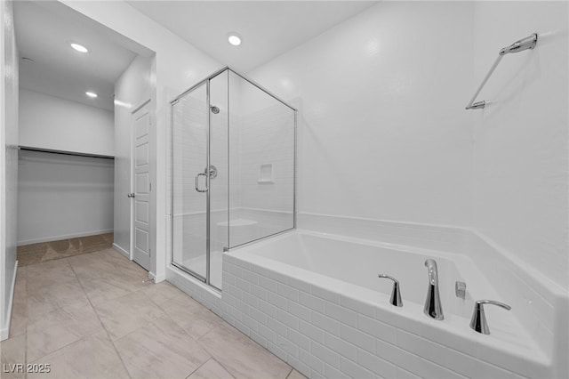 bathroom featuring shower with separate bathtub