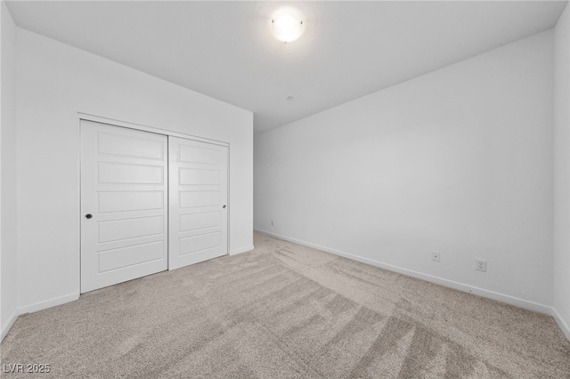 unfurnished bedroom with carpet flooring and a closet