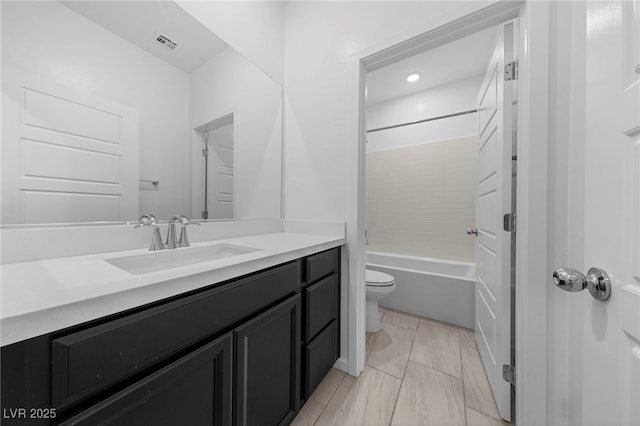 full bathroom featuring vanity, washtub / shower combination, and toilet