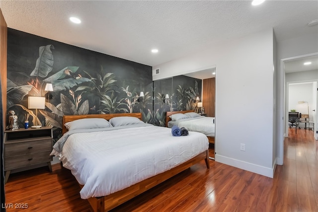 bedroom featuring hardwood / wood-style floors and a textured ceiling