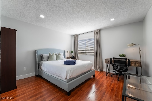 bedroom with dark wood-type flooring and a textured ceiling