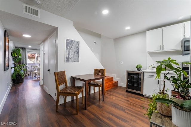 dining room featuring dark hardwood / wood-style flooring and beverage cooler