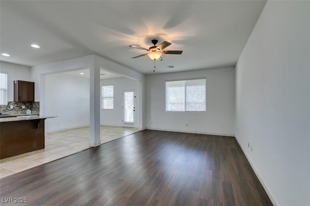 unfurnished living room featuring ceiling fan and light hardwood / wood-style flooring