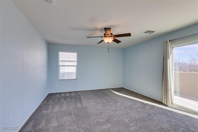 carpeted empty room with a wealth of natural light and ceiling fan